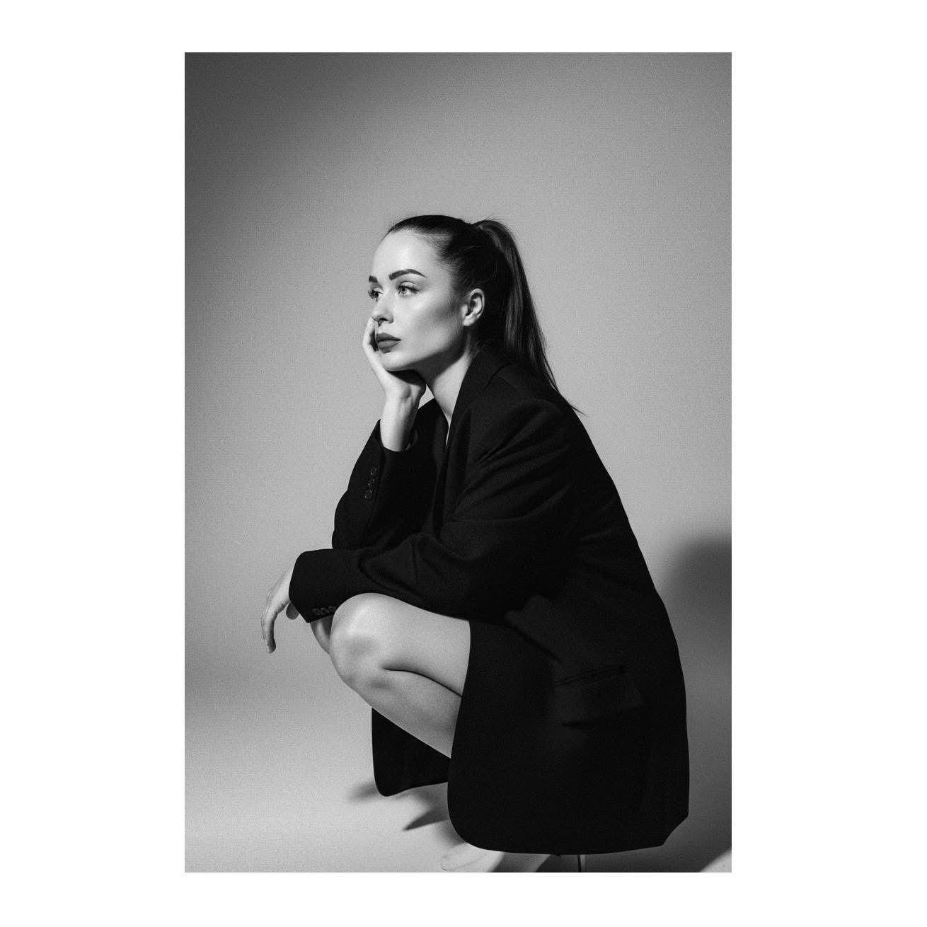 Black and white portrait of Kamilla Csigás, creator of Femme Code, wearing a black blazer.